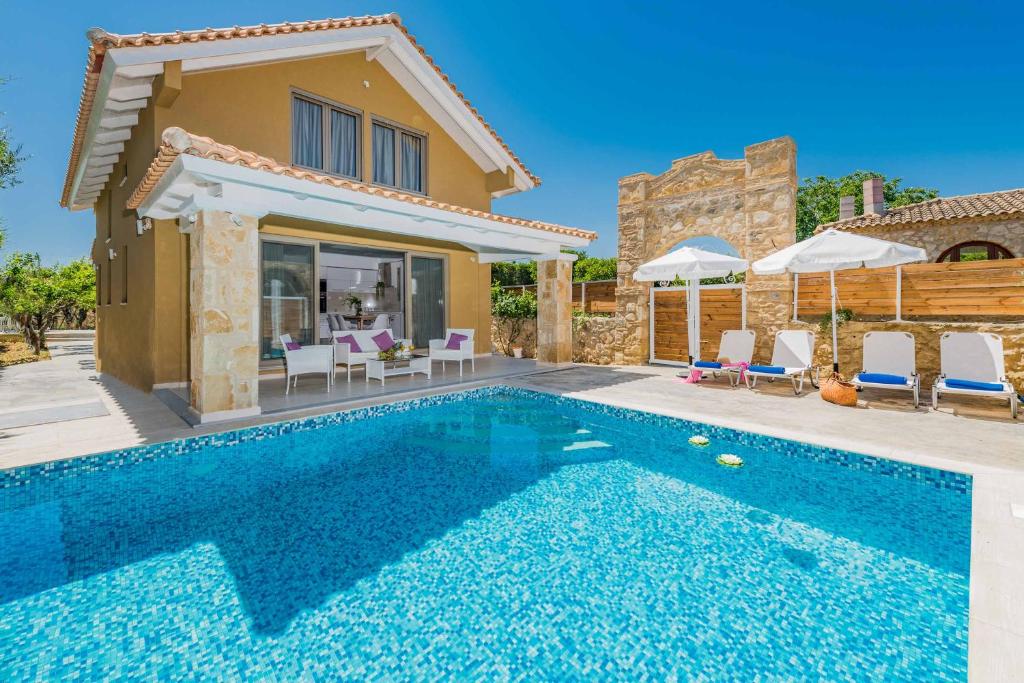 a villa with a swimming pool and a house at Villa Lefki Sofita in Makris Gialos