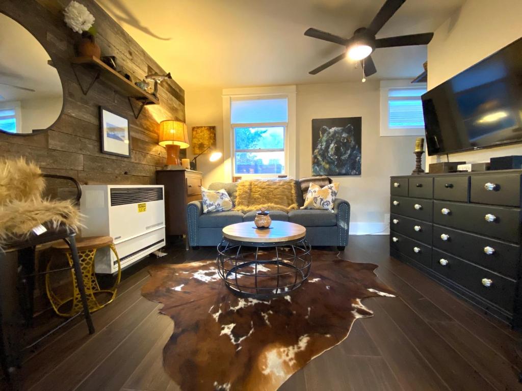 a living room with a couch and a table at The Chic Guest Retreat in Old Town near CSU! in Fort Collins