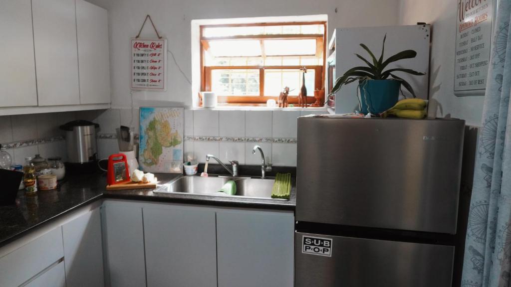 a kitchen with a stainless steel refrigerator and a sink at El Sofá Caracas in Caracas