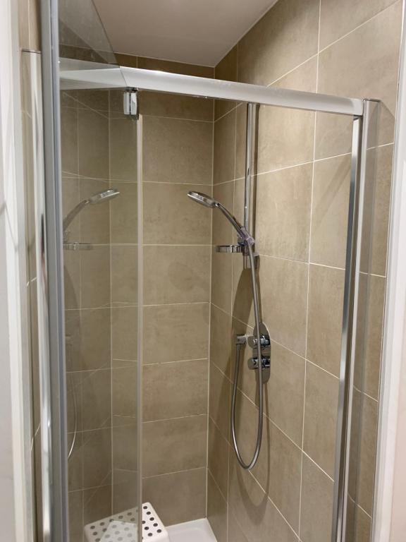 a shower with a glass door in a bathroom at Countryside Luxury House Harlow in Harlow