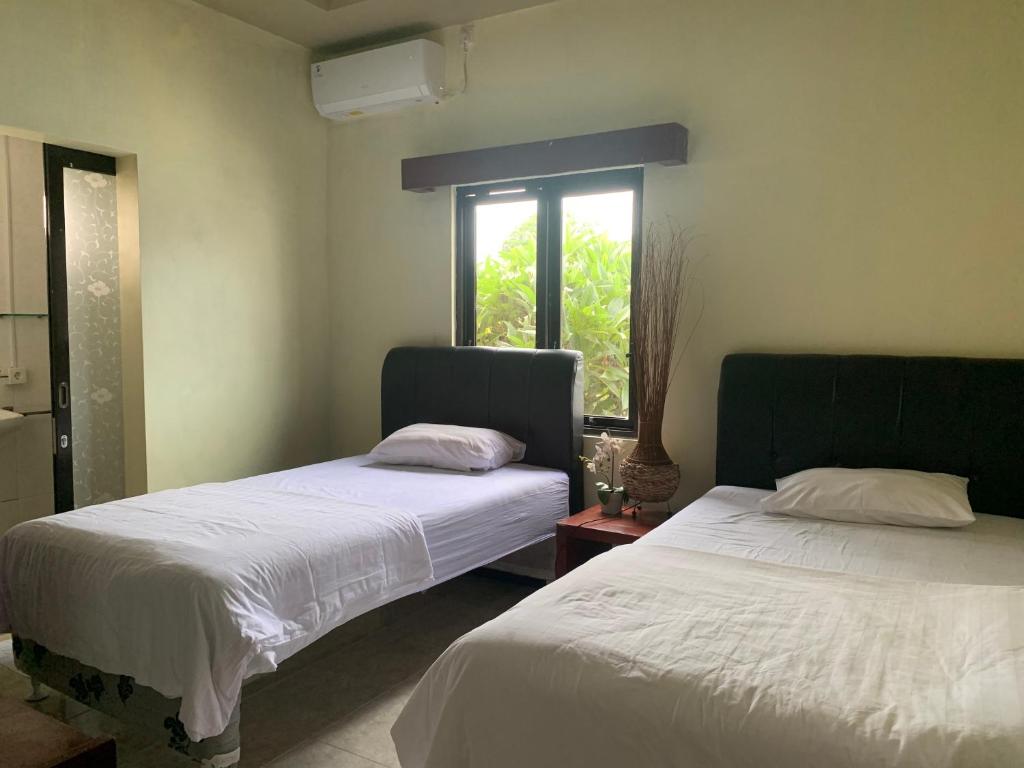 Postel nebo postele na pokoji v ubytování Cozy Palm Villa