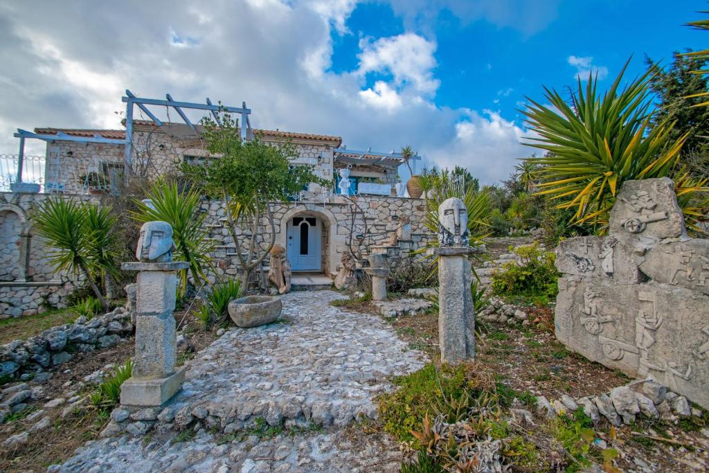 a stone house with a stone path in front of it at Villa Voula in Koiliomenos