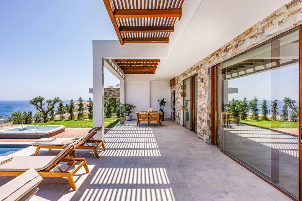 an outdoor patio with a view of the ocean at Avgi Thesan in Marathias