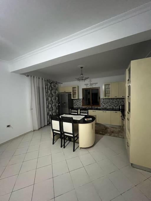 a large kitchen with a table and chairs in it at City view in Elbasan