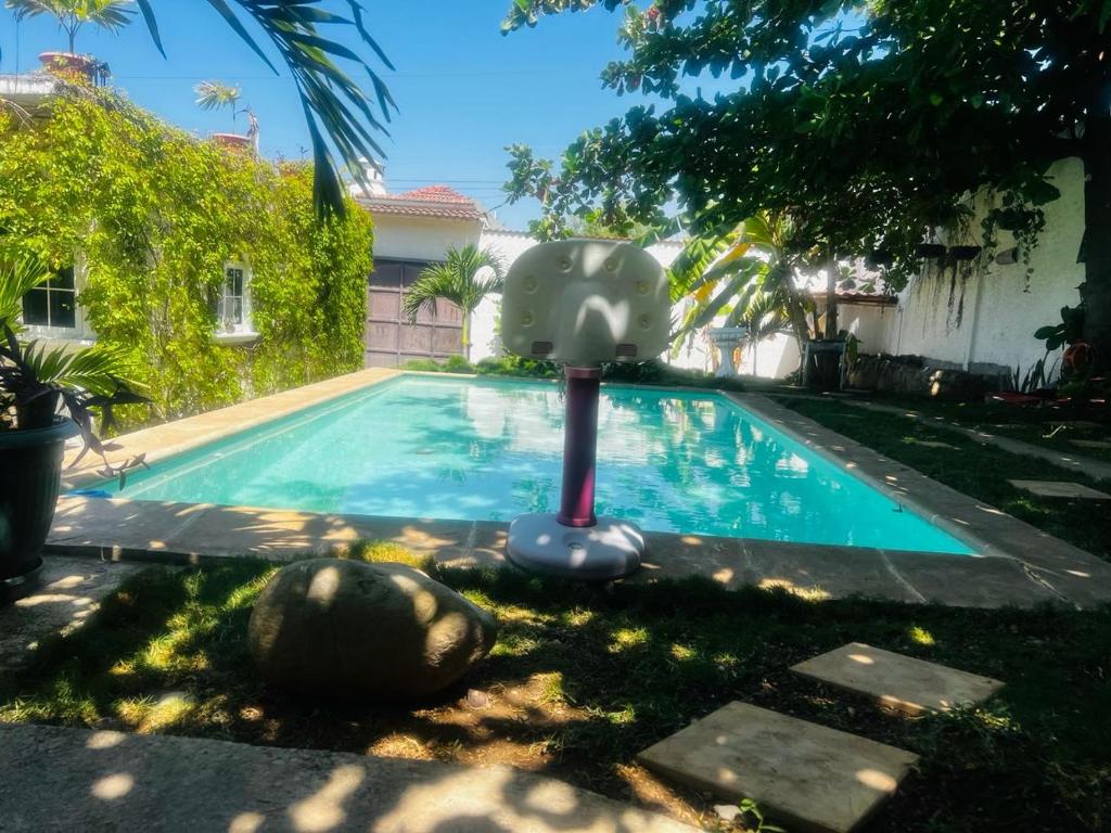 a swimming pool with a plastic object in a yard at Garden house, 1 km de pradera chiquimula in Chiquimula