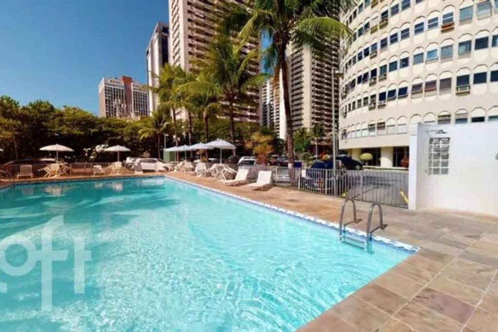 a large swimming pool in the middle of a city at Apê na Barra vista incrível in Rio de Janeiro