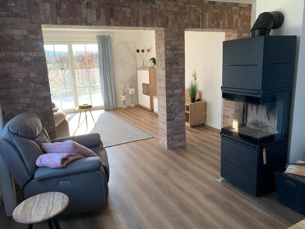 ein Wohnzimmer mit einem Sofa und einem Kamin in der Unterkunft Außergewöhnliche Ferienwohnung in modernen Styl in Weiding
