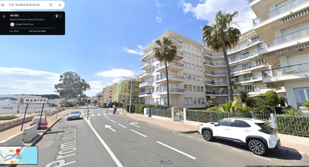 a white car parked on the side of a city street at Résidence La Piscine - 3 Pièces pour 6 Personnes 261 in Menton