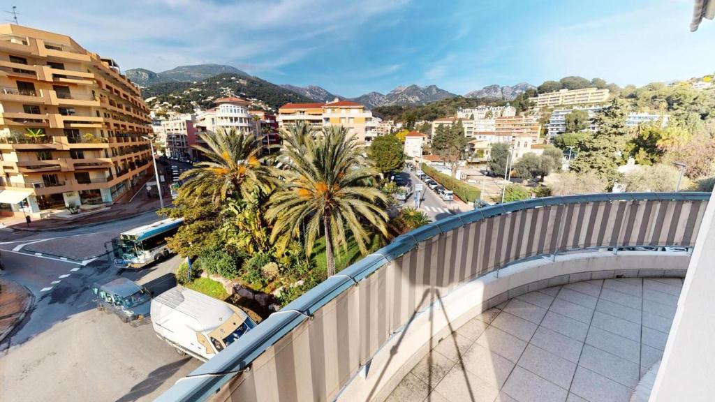 a bridge over a city with palm trees and buildings at Résidence La Piscine - 3 Pièces pour 6 Personnes 261 in Menton