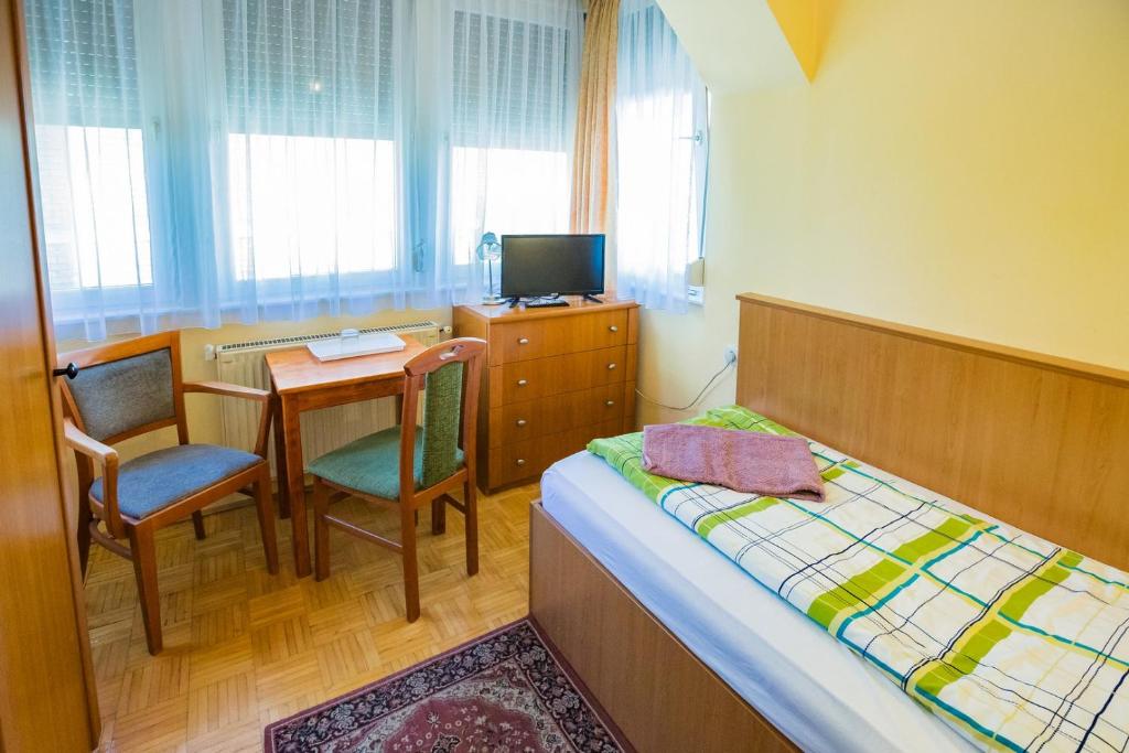 Postel nebo postele na pokoji v ubytování Mohacsi Guesthouse