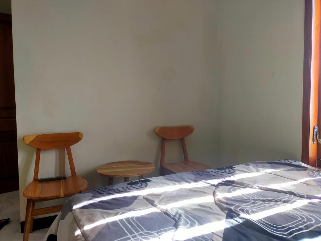 Postel nebo postele na pokoji v ubytování Bromo Seruni Astungkara Homestay