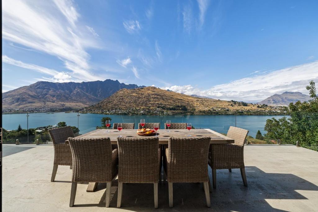 a table and chairs with a view of a lake at Remarkable Views on Goldrush in Queenstown