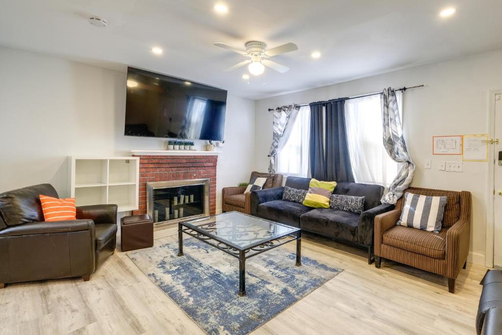 a living room with couches and a fireplace at Oxon Hill Rental about 3 miles to MGM National Harbor in Oxon Hill