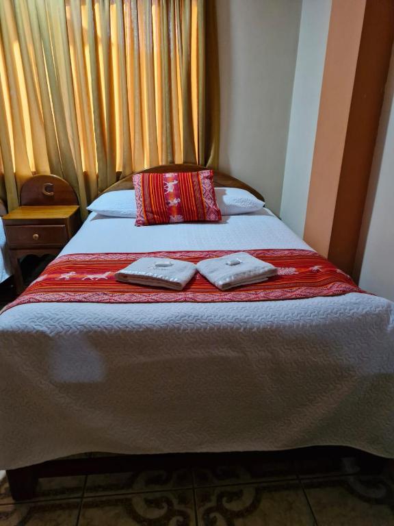 Postel nebo postele na pokoji v ubytování Hotel Colquewasi
