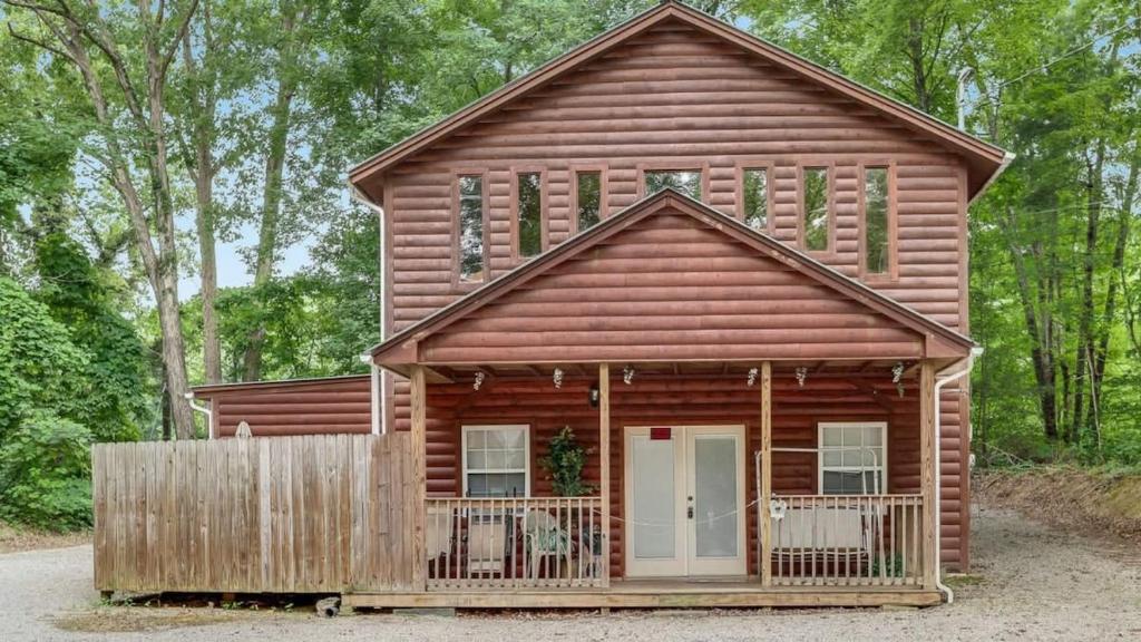 a log cabin with a fence in front of it at The Cave at Shady Woods - 1 Bedroom Studio - Walk to Downtown! in Gatlinburg