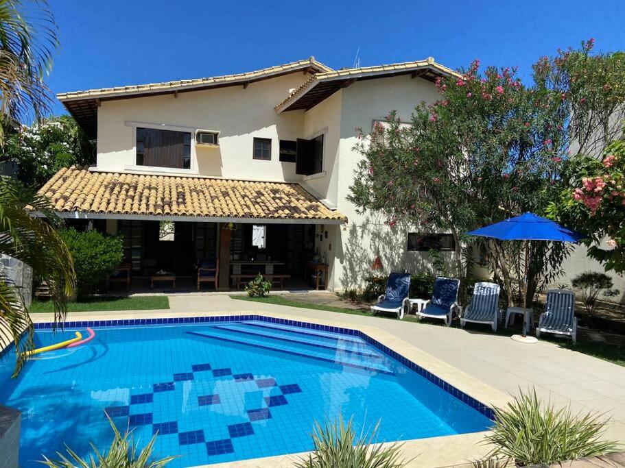 a swimming pool in front of a house at Vila Atlântica - House in Vilas do Atlântico in Lauro de Freitas