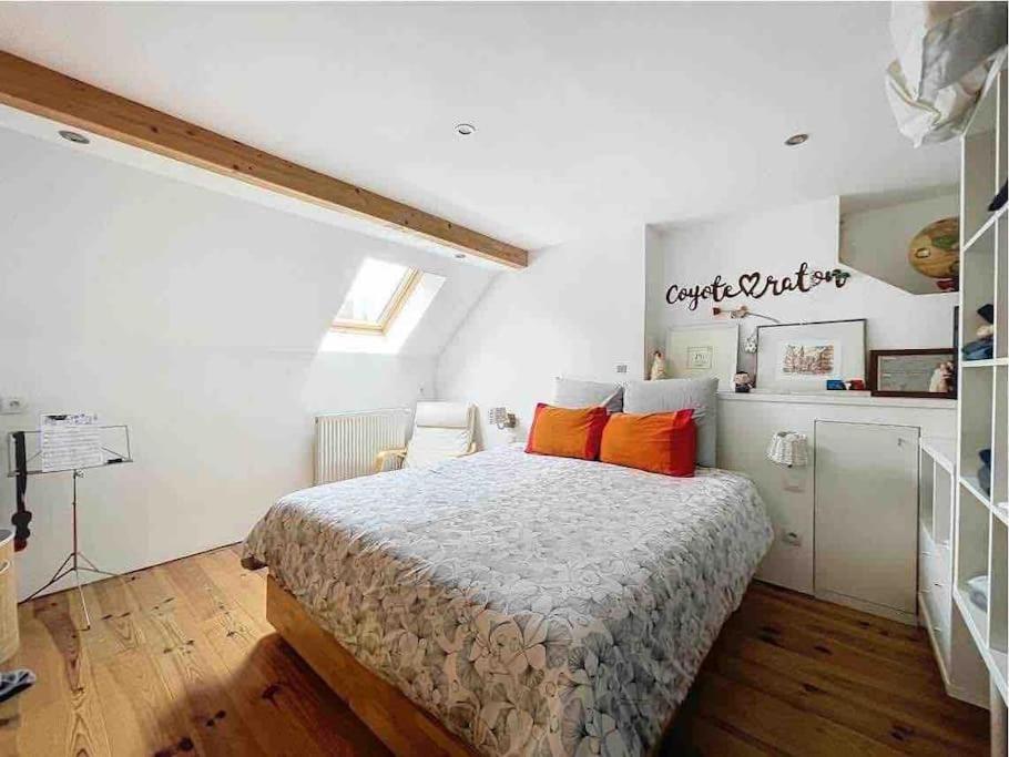 een slaapkamer met een bed met oranje kussens erop bij Charleville 39 J Bruxelles-charleroi-aéroport in Charleroi