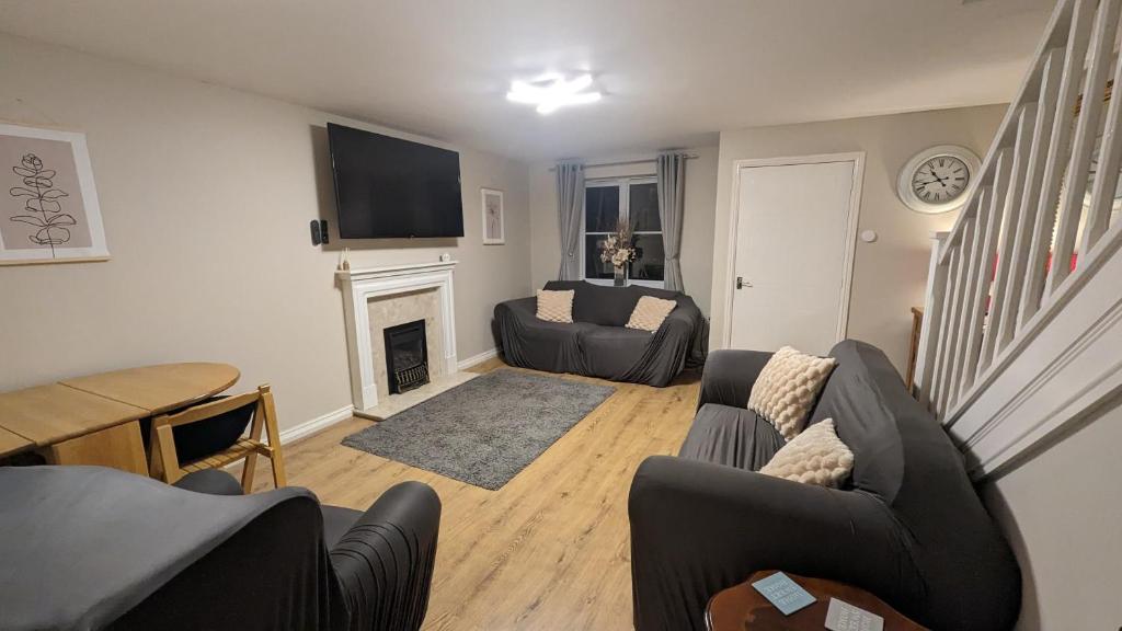 a living room with a couch and a fireplace at 3 bedroom detached by the sea in Prestatyn