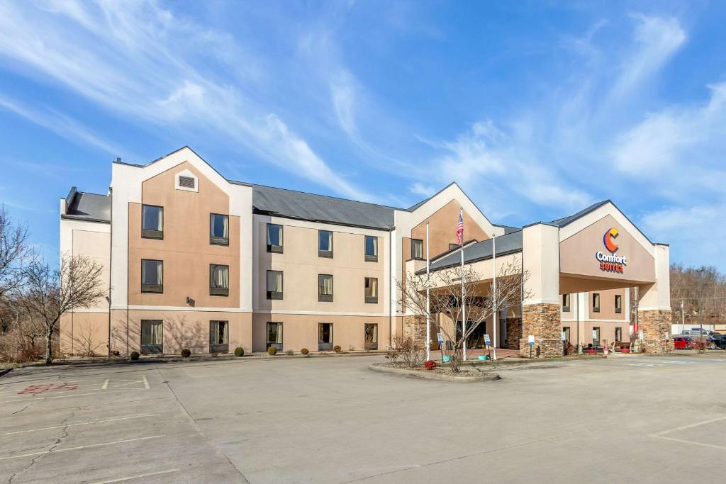 a large building with a parking lot in front of it at Comfort Suites South Point - Huntington in Burlington