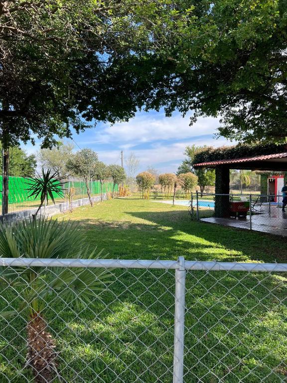 a fence in front of a park with a playground at Quinta don juanito in Monterrey