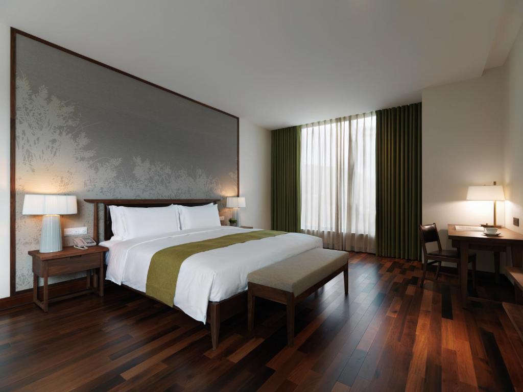 Postel nebo postele na pokoji v ubytování Yusense Hotel