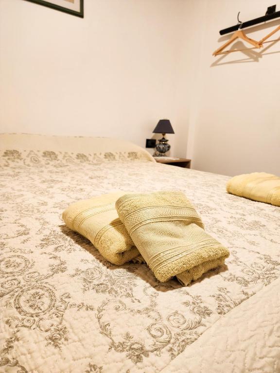 a bedroom with a bed with two pillows on it at Departamento DORREGO, A estrenar in Guaymallen
