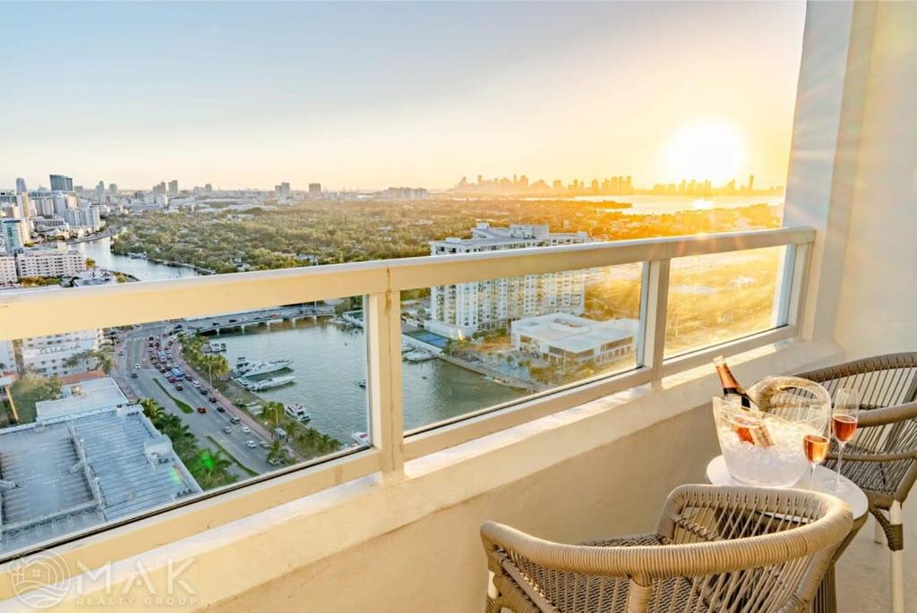 a balcony with chairs and a view of a river at FontaineBleau Resort High Floor w Ocean Views in Miami Beach