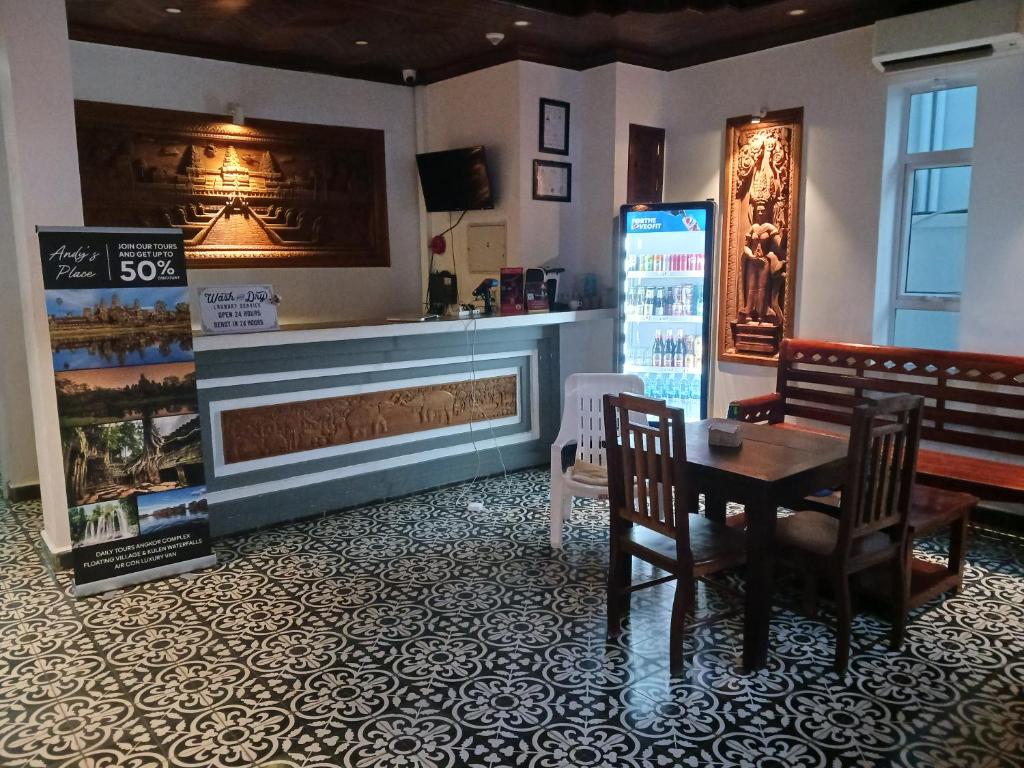 a dining room with a table and a refrigerator at Andy's Place in Siem Reap