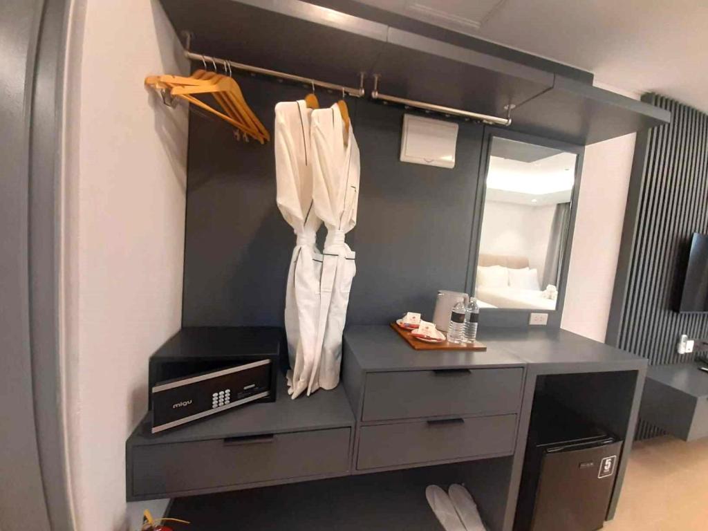 a bathroom with a dresser and a mirror at The Clover Hotel in Angeles