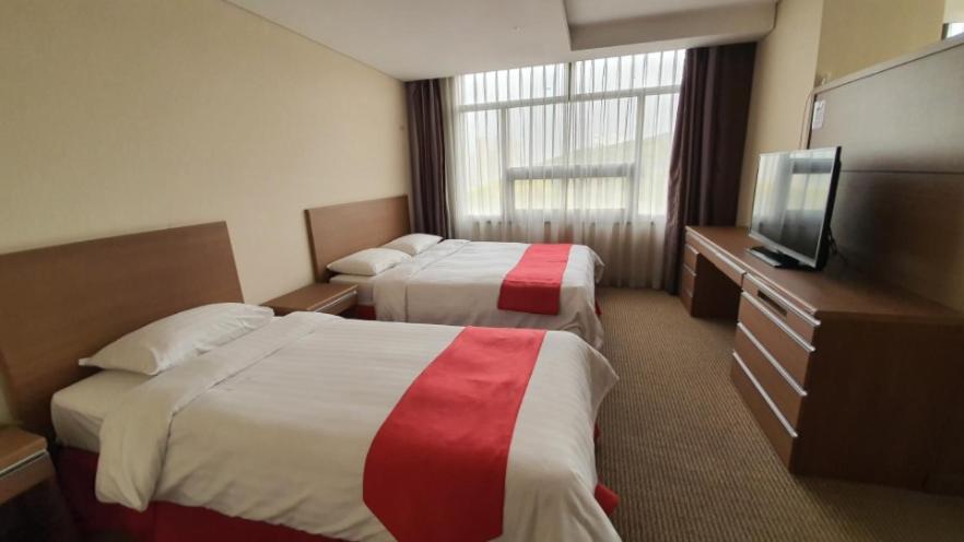 Postel nebo postele na pokoji v ubytování Ramada by Wyndham Dongtan