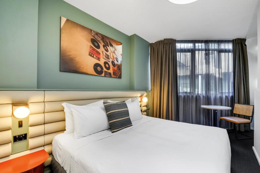 a hotel room with a bed and a window at The Urban Newtown in Sydney
