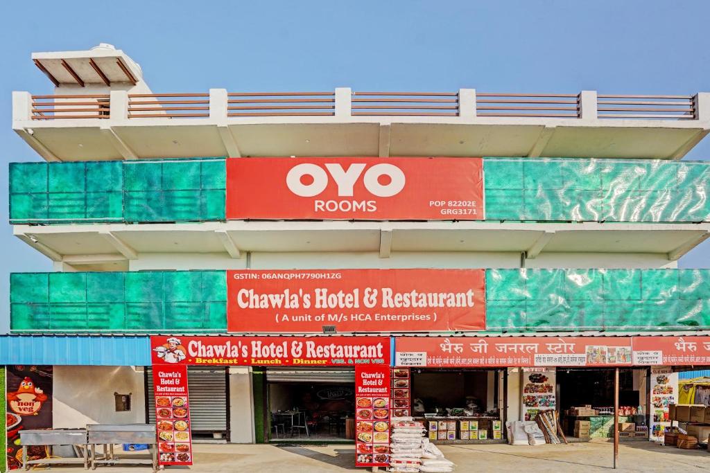 a store with orange and red signs on a building at Super OYO Chawla's Hotel & Restaurant in Gurgaon