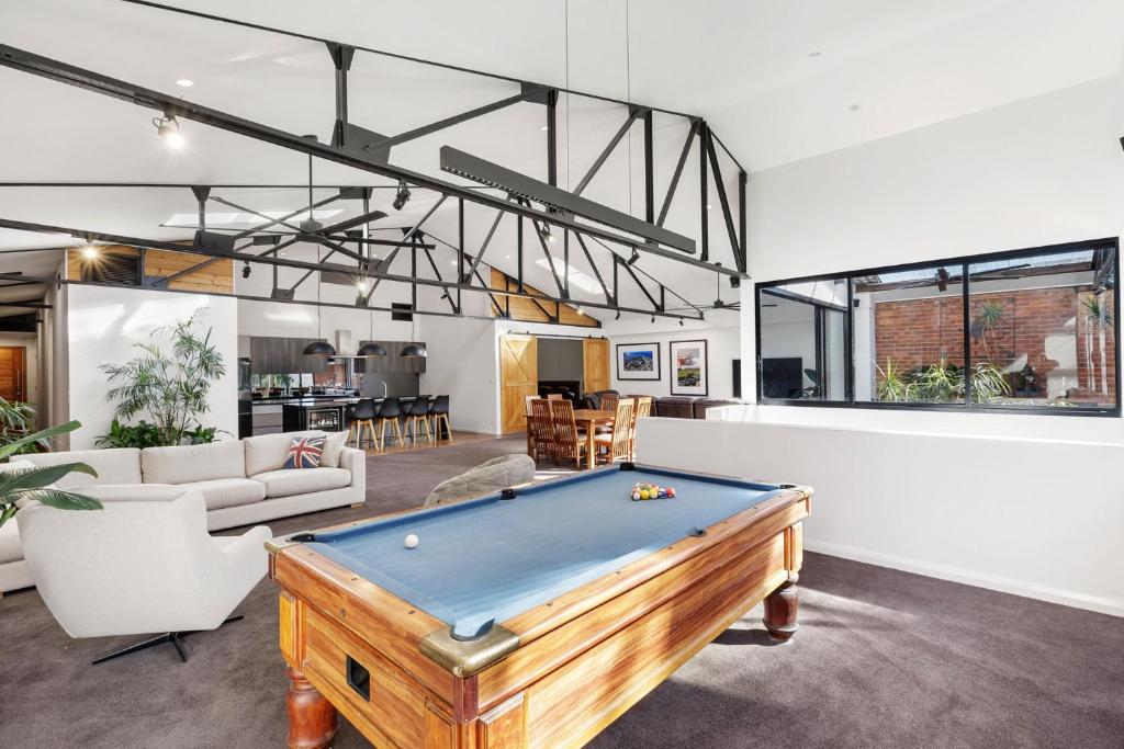 a living room with a pool table in it at Platinum Precinct - The Penthouse in Newcastle