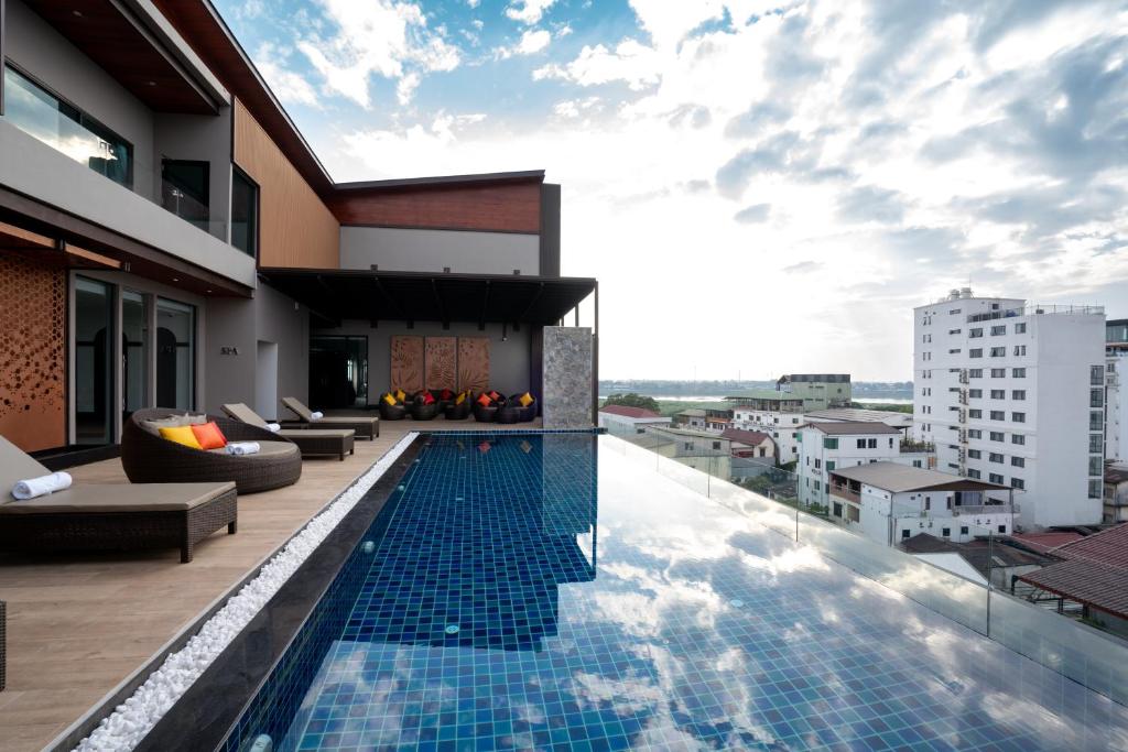 a swimming pool on the roof of a building at Mintra Hotel in Vientiane