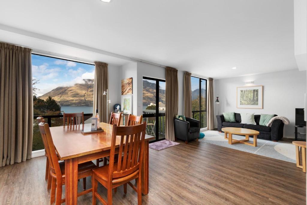 a dining room and living room with a table and chairs at The Twins in Queenstown