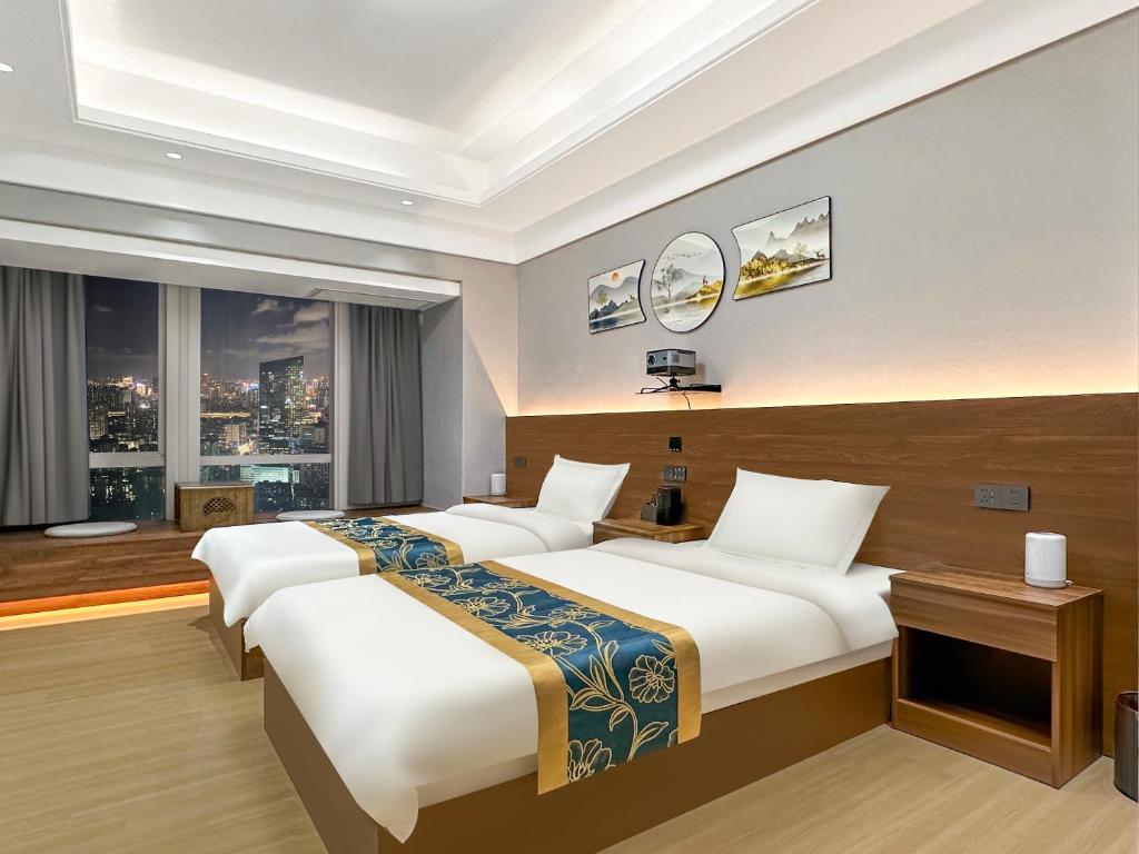 Postel nebo postele na pokoji v ubytování Xingyin Cloudy Hotel Guangzhou Changgang Subway Station - Free Shuttle Bus to Canton Fair Complex During Canton Fair Period