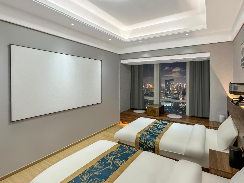Postel nebo postele na pokoji v ubytování Xingyin Cloudy Hotel Guangzhou Changgang Subway Station - Free Shuttle Bus to Canton Fair Complex During Canton Fair Period