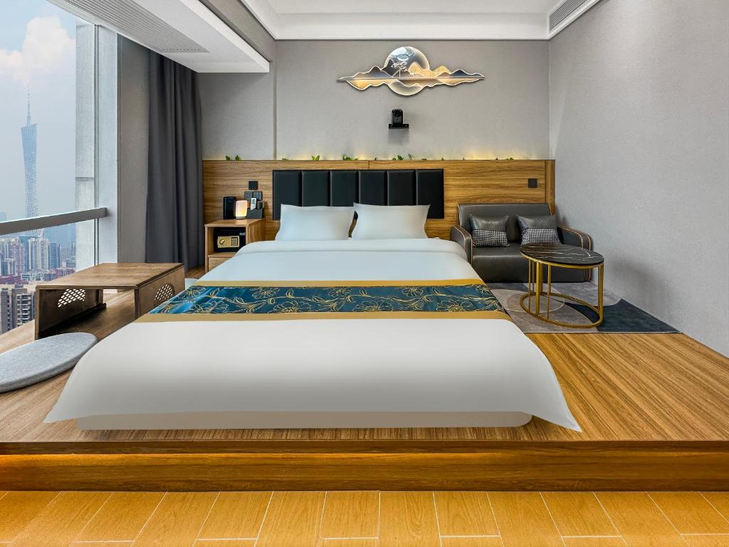 Postel nebo postele na pokoji v ubytování Xingyin Cloudy Hotel Guangzhou Changgang Subway Station - Free Shuttle Bus to Canton Fair Complex During Canton Fair Period
