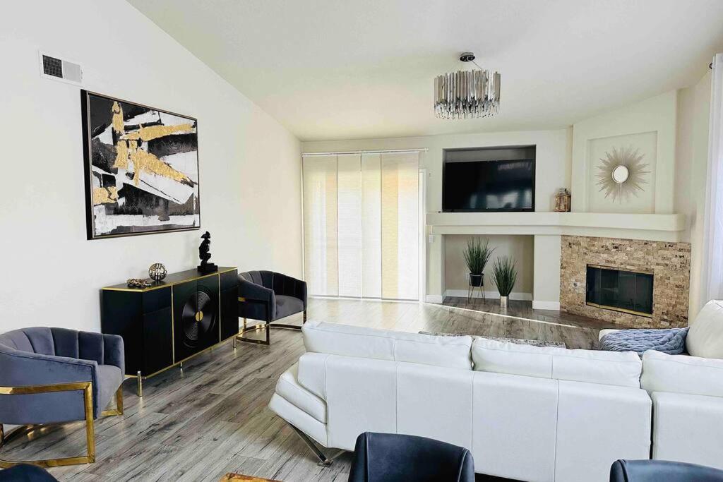 a living room with a white couch and a fireplace at Sweet Holiday in Antelope