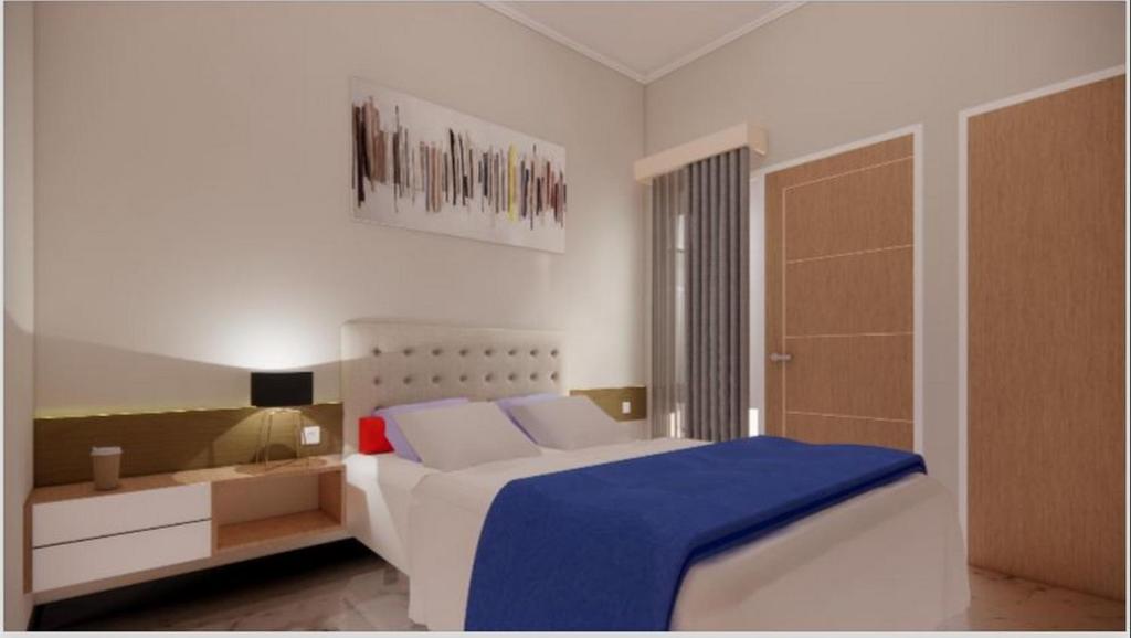 1 dormitorio con 1 cama con manta azul en Sumarsi Homestay Mitra RedDoorz en Demangan
