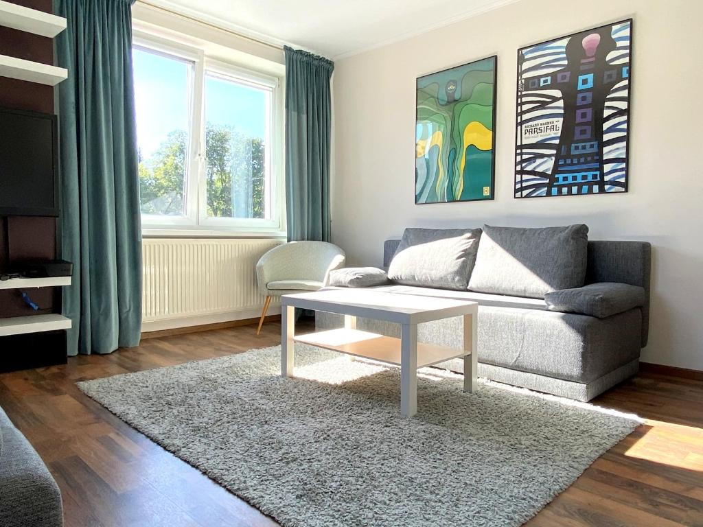 a living room with a couch and a coffee table at Helska Space by Grand Apartments in Sopot