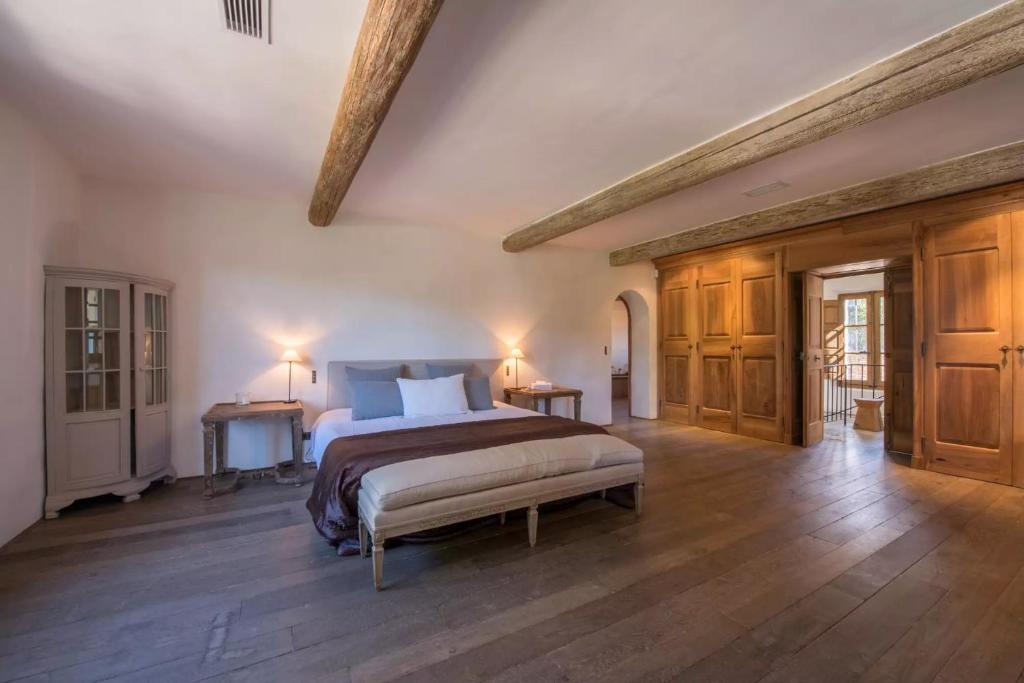 a large bedroom with a bed and wooden floors at Jansson Stars ***** in Saint-Tropez