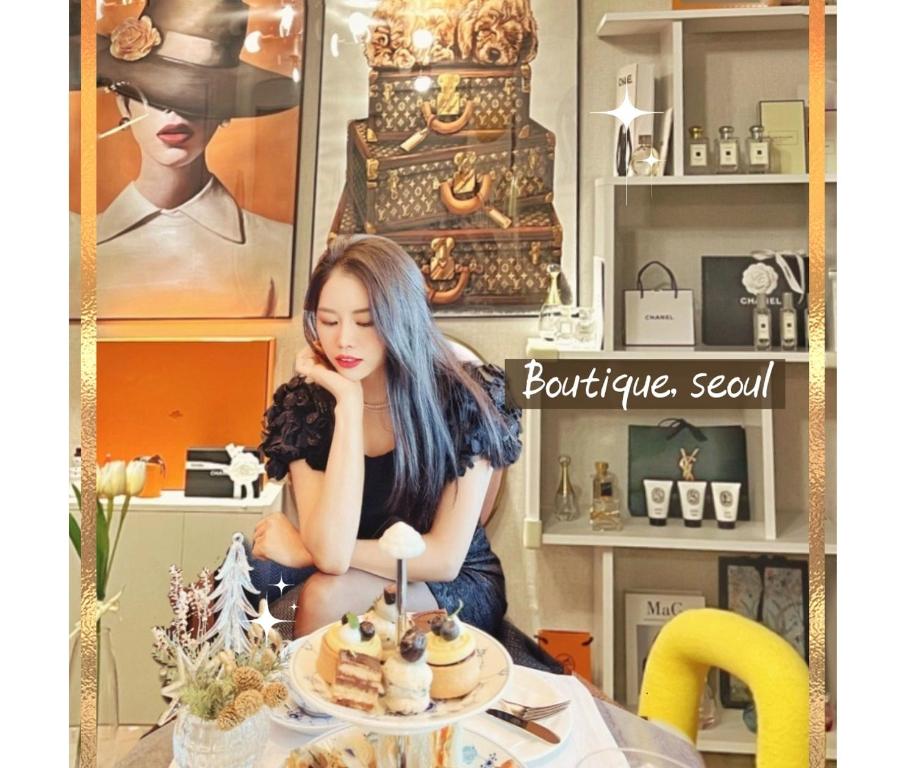 a woman sitting at a table with a plate of food at Boutique,seoul in Seoul