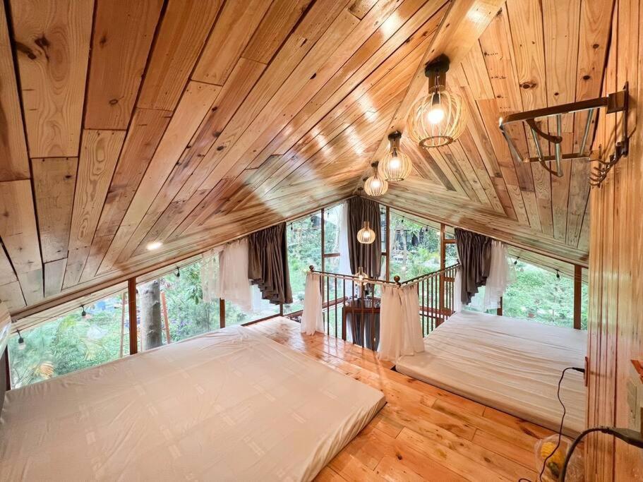 a bedroom with a large bed in a room with wooden ceilings at Căn Hana ( Moon Villa Sóc Sơn) in Hanoi