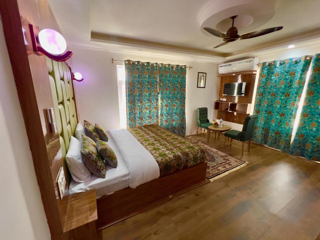 a bedroom with a bed and a table and chairs at Pandith Exotics Hotel And Restaurant in Gulmarg