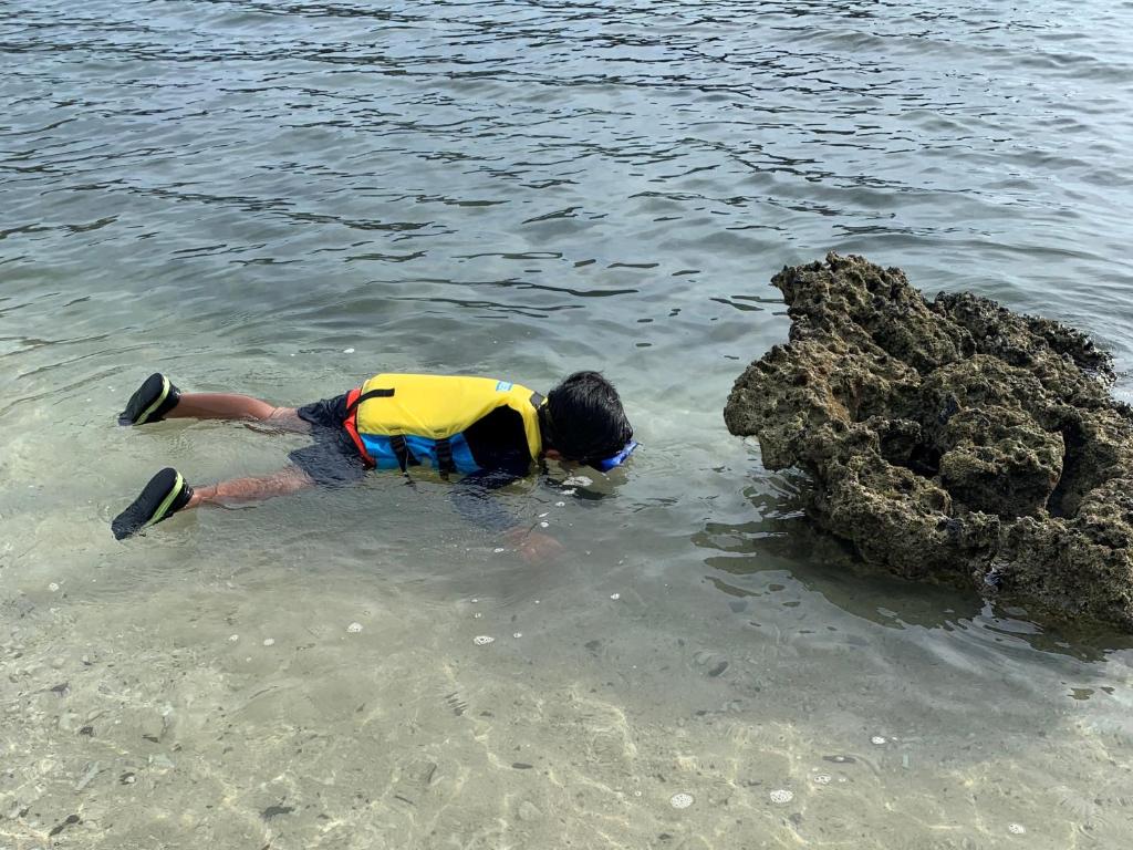 a man in the water with a life vest at HOTEL KANALOA in Tokashiki