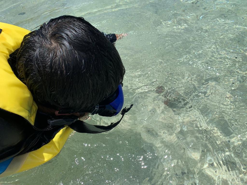 a person wearing a life vest in the water at HOTEL KANALOA in Tokashiki