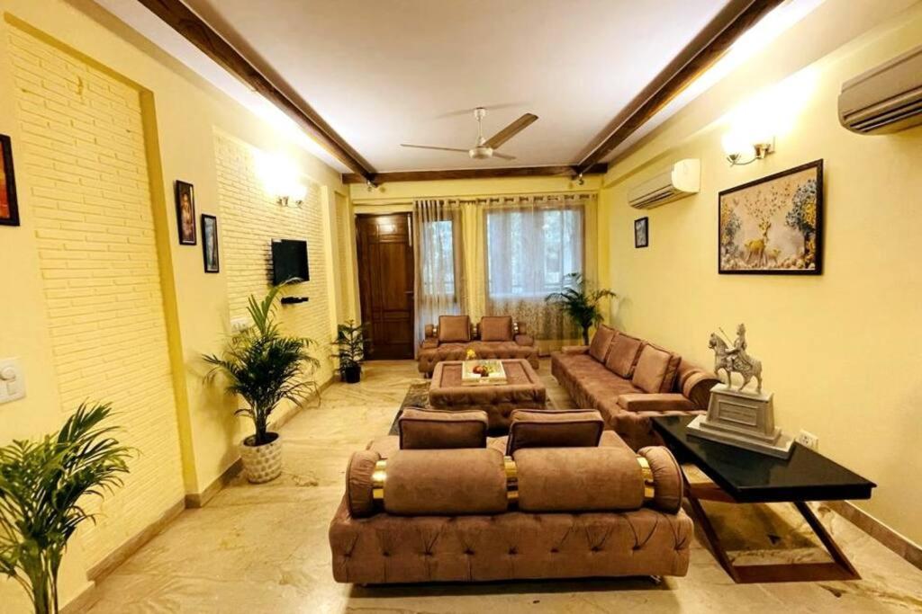 a living room with a couch and a table at Divine India Service Apartment 4Bhk,D-36, Saket in New Delhi