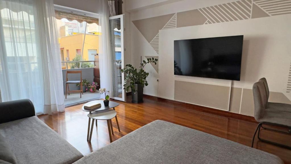 a living room with a large flat screen tv at Two bedroom luxury apartment. in Athens