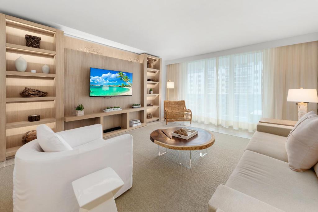 a living room with a white couch and a tv at Oceanview Private Condo at 1 Hotel & Homes -1208 in Miami Beach